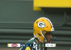 A.J. Dillion slips past defenders on his first rush for 14 yards