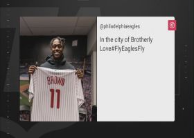 A.J. Brown holds up his custom-made Phillies jersey