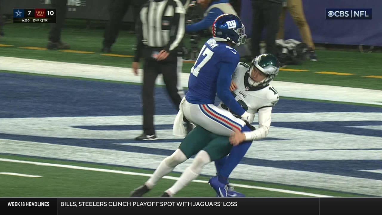 New York Giants linebacker Cam Brown holds Eagles punter Braden Mann in