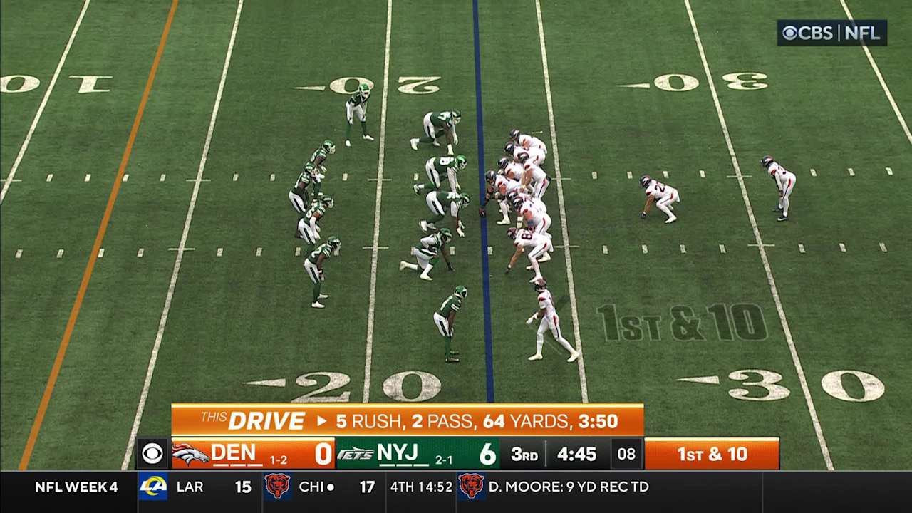 Denver Broncos running back Javonte Williams flexes muscles after