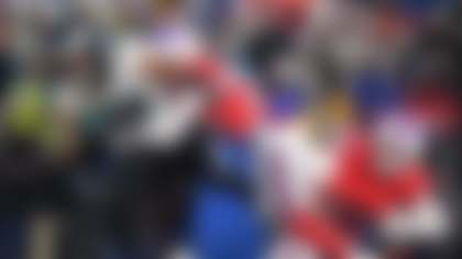 Philadelphia Eagles' Saquon Barkley, left, is tackled by Buffalo Bills' Cam Lewis, center, and Cole Bishop during the first half of an NFL football game, Sunday, Dec. 28, 2025, in Buffalo, N.Y. (AP Photo/Adrian Kraus)