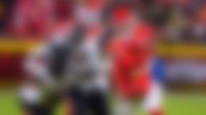 Kansas City Chiefs quarterback Patrick Mahomes (15) scrambles away from Houston Texans linebacker Azeez al-Shaair (0) during the second half of an NFL football game Sunday, Dec. 7, 2025, in Kansas City, Mo. (AP Photo/Charlie Riedel)