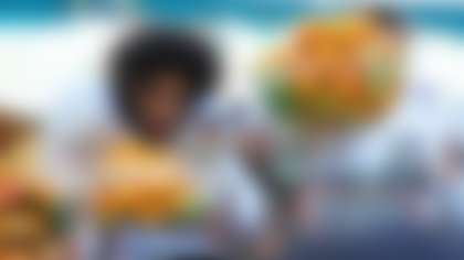 Oregon quarterback Dante Moore looks at the MVP trophy after Oregon defeated Texas Tech in the Orange Bowl College Football Playoff quarterfinal game, Thursday, Jan. 1, 2026, in Miami Gardens, Fla. (AP Photo/Lynne Sladky)