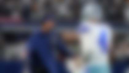 Dallas Cowboys head coach Brian Schottenheimer greets Dak Prescott (4) at the sideline in the first half of an NFL football game against the Green Bay Packers Sunday, Sept. 28, 2025, in Arlington, Texas. (AP Photo/Jeffrey McWhorter)
