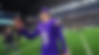 Minnesota Vikings quarterback J.J. McCarthy (9) records a video on a cell phone during an NFL football game between the Dallas Cowboys and the Minnesota Vikings Sunday, Dec. 14, 2025, in Arlington, Texas. (AP Photo/Julio Cortez)