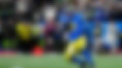 Los Angeles Rams defensive end Kobie Turner (91) intercepts the ball during an NFL football game against the Seattle Seahawks, Thursday, Dec. 18, 2025 in Seattle. (AP Photo/Ben VanHouten)