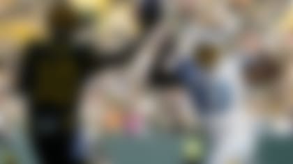 Green Bay Packers quarterback Jordan Love (10) attempts a pass as Los Angeles Chargers defensive tackle Otito Ogbonnia (93) applies pressure during the first half of an NFL football game, Sunday, Nov. 19, 2023, in Green Bay, Wis. (AP Photo/Morry Gash)