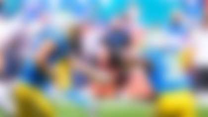 Los Angeles Chargers quarterback Justin Herbert (10) hands off the ball to running back Kimani Vidal (30) during an NFL football game against the Miami Dolphins, Sunday, Oct. 12, 2025, in Miami Gardens, Fla. (AP Photo/Doug Murray)