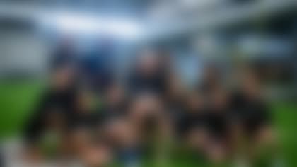 Las Vegas Raiders defensive end Maxx Crosby (98) poses for a photo with participants during the Raiders Skills Camp at Intermountain Healthcare Performance Center, Saturday, July 9, 2022, in Henderson, Nev.