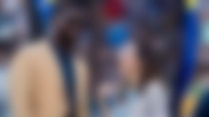 Rojas, pictured with Hall of Fame running back LaDainian Tomlinson, spearheads several departments within the organization, including the alumni program. (Photo courtesy of Jennifer Rojas)