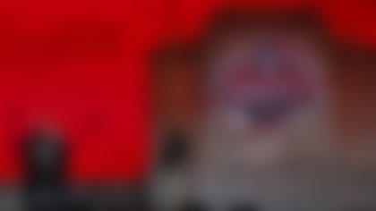 Texas running back Bijan Robinson (left) holds up a jersey with NFL Commissioner Roger Goodell after being picked by the Atlanta Falcons with the eighth overall pick in the first round during the 2023 NFL football draft, Thursday, April 27, 2023, in Kansas City, Mo. (Aaron M. Sprecher via AP)