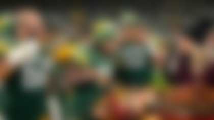 Green Bay Packers quarterback Jordan Love (10), linebacker Isaiah McDuffie (58), and running back Josh Jacobs (8) enjoy Thanksgiving turkey with NBC Sports reporter Melissa Stark after an NFL football game against the Miami Dolphins, Thursday, Nov. 28, 2024 in Green Bay, Wis. (Todd Rosenberg via AP)