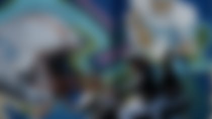 Motorcyclists drive past a mural commemorating a 1994 NFL football game between the Houston Oilers and the Dallas Cowboys played in Mexico, in Mexico City, Friday, Nov. 17, 2017. The NFL is back in Mexico this week as the city gears up for a matchup between the New England Patriots and the Oakland Raiders in Aztec Stadium on Sunday, Nov. 19. (AP Photo/Gregory Bull)