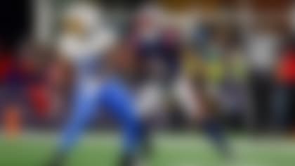 Los Angeles Chargers running back Kimani Vidal (30) is defended by New England Patriots cornerback Christian Gonzalez (0) during the second half of an NFL wild card playoff football game, Sunday, Jan. 11, 2026, in Foxborough, Mass. (AP Photo/Greg M. Cooper)