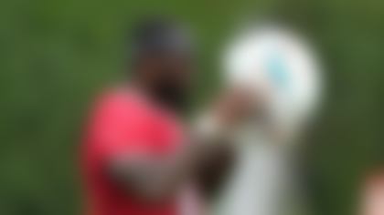 Miami Dolphins quarterback Tyler Huntley puts on his helmet during practice at the NFL football team's training facility, Wednesday, Sept. 18, 2024, in Miami Gardens, Fla. (AP Photo/Lynne Sladky)