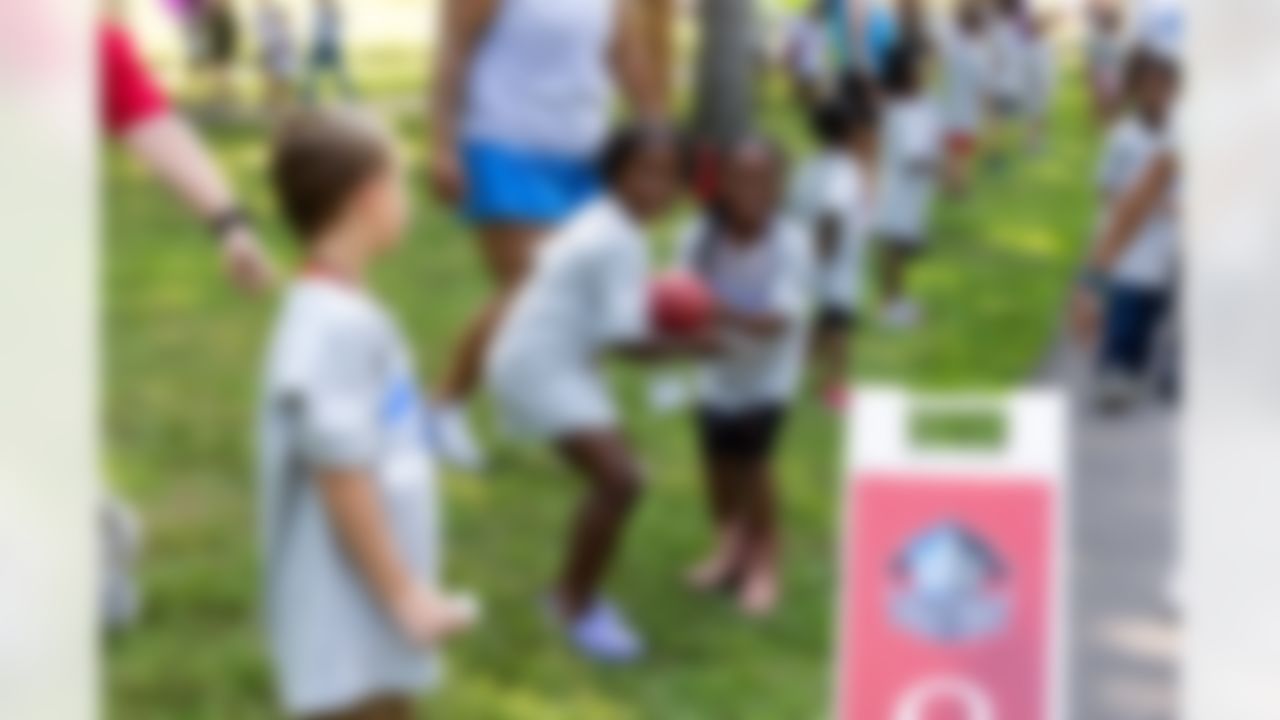 Kids pass the football during the Play Football First Play on Wednesday, July 30, 2025 in Canton.