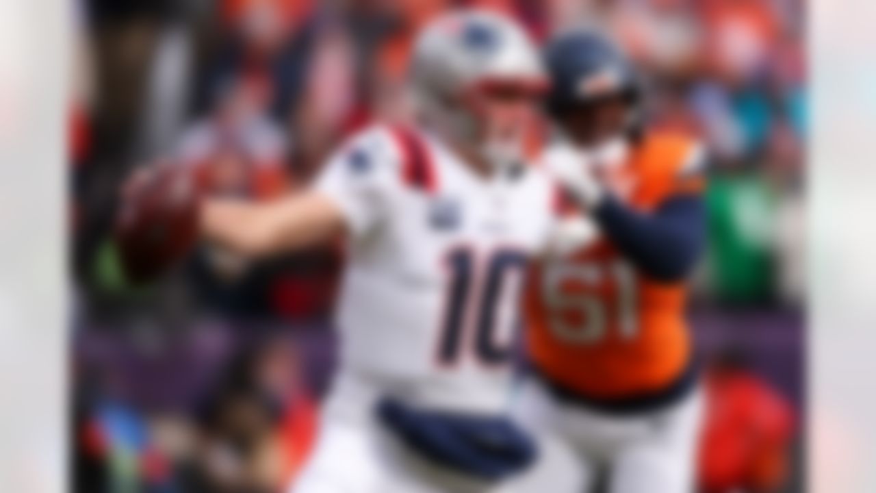 New England Patriots quarterback Drake Maye (10) stiff arms during an NFL football game against the Denver Broncos on Sunday, January 25, 2026 in Denver, Colorado.