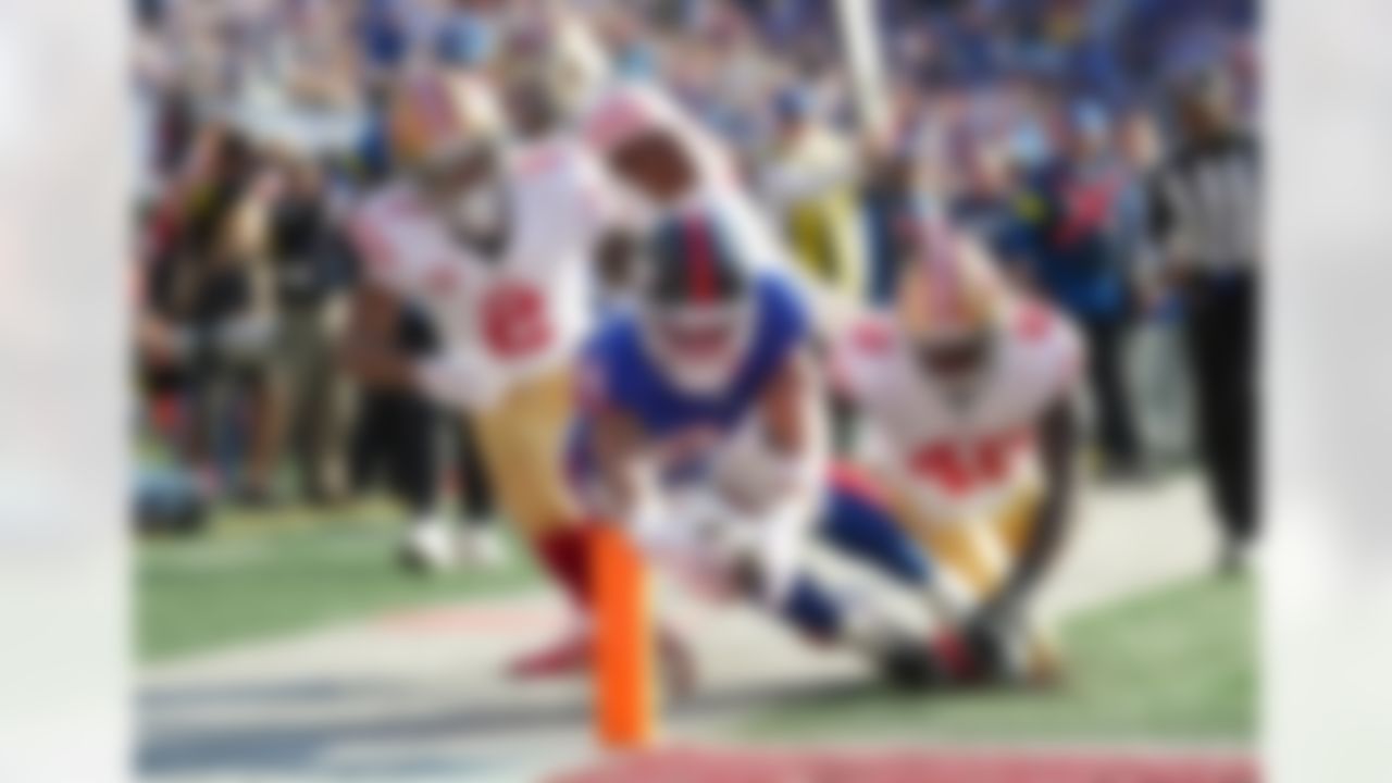 New York Giants tight end Theo Johnson (84) dives for a touchdown during an NFL football game against the San Francisco 49ers, Sunday, Nov. 2, 2025, in East Rutherford, New Jersey.