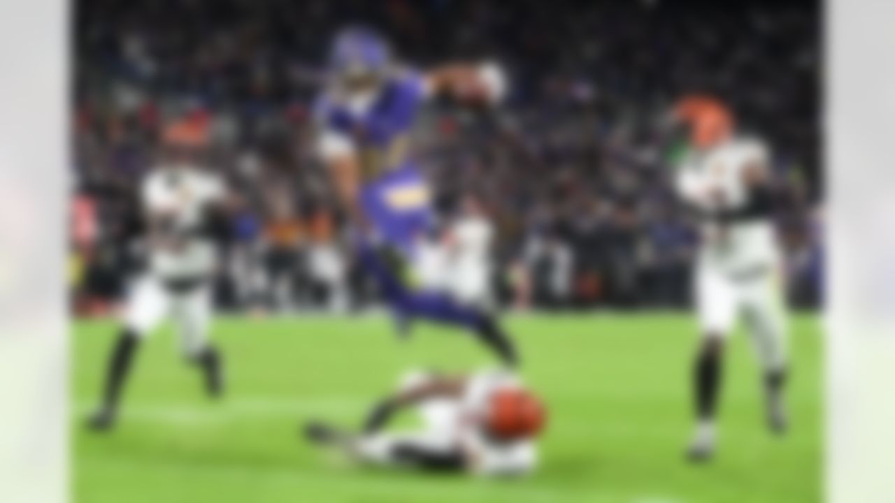 Baltimore Ravens tight end Isaiah Likely (80) hurdles Cincinnati Bengals safety Geno Stone (22) as Cincinnati Bengals cornerback Jalen Davis (35) and safety Jordan Battle (27) move in on the play during the first half of an NFL football game, Thursday, Nov. 27, 2025, in Baltimore.