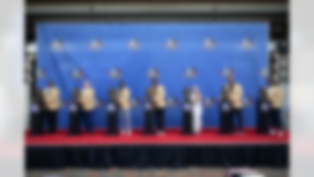 The Pro Football Hall of Fame Class of 2024 poses with their busts after an induction ceremony at the Pro Football Hall of Fame, in Canton, Ohio, Saturday, Aug. 3, 2024. From left are; Dwight Freeney, Randy Gradishar, Devin Hester, Andre Johnson, Misty McMichael, wife of Steve McMichael, Julius Peppers, and Patrick Willis.