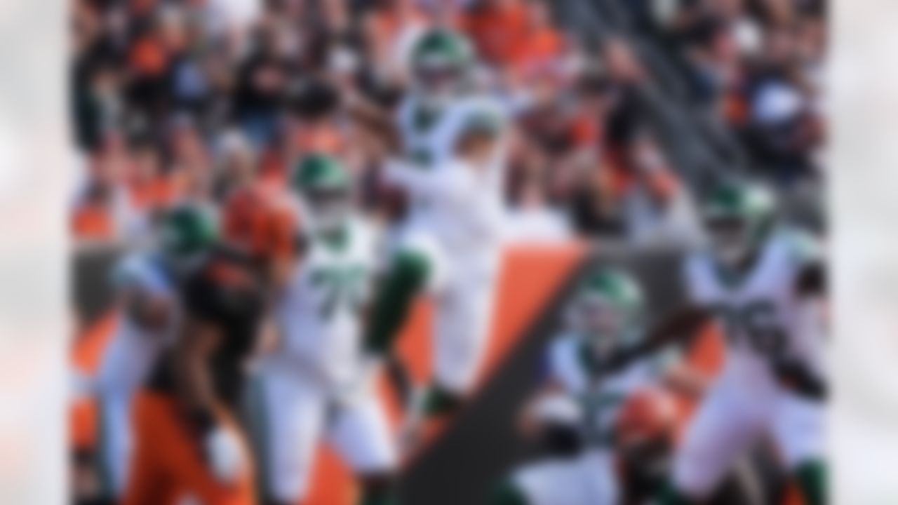 New York Jets quarterback Justin Fields (7) leaps past the line of scrimmage during the second half of an NFL football game against the Cincinnati Bengals, Sunday, Oct. 26, 2025, in Cincinnati.