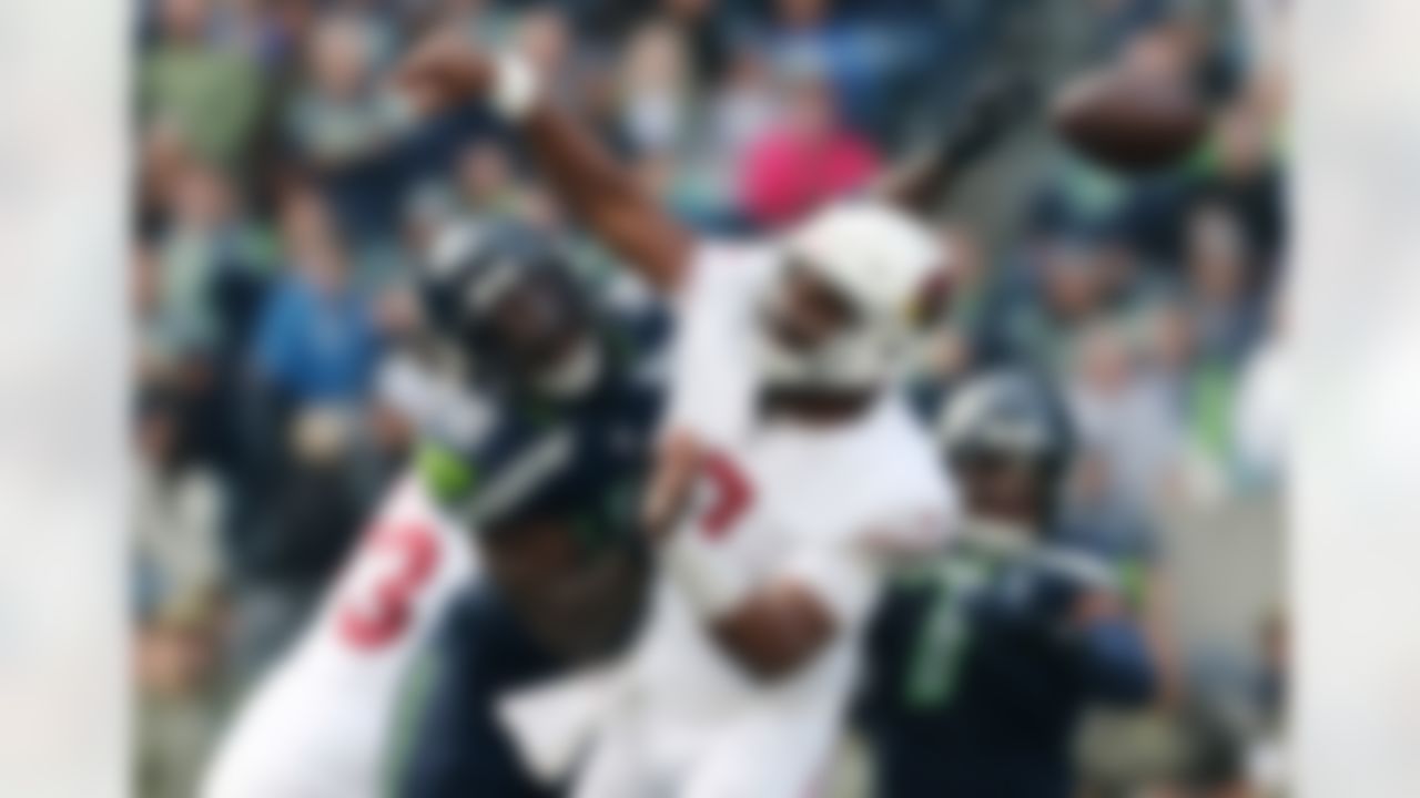 Seattle Seahawks linebacker Tyrice Knight (48) causes a fumble by Arizona Cardinals quarterback Jacoby Brissett, right, during the first half of an NFL football game Sunday, Nov. 9, 2025, in Seattle.