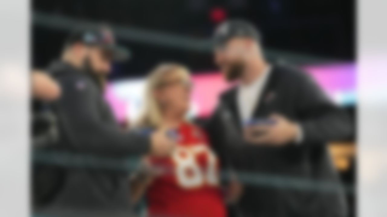 Donna Kelce greets her sons, Philadelphia Eagles center Jason Kelce, left, and Kansas City Chiefs tight end Travis Kelce during the NFL football Super Bowl 57 opening night, Monday, Feb. 6, 2023, in Phoenix. The Kansas City Chiefs will play the Philadelphia Eagles on Sunday.