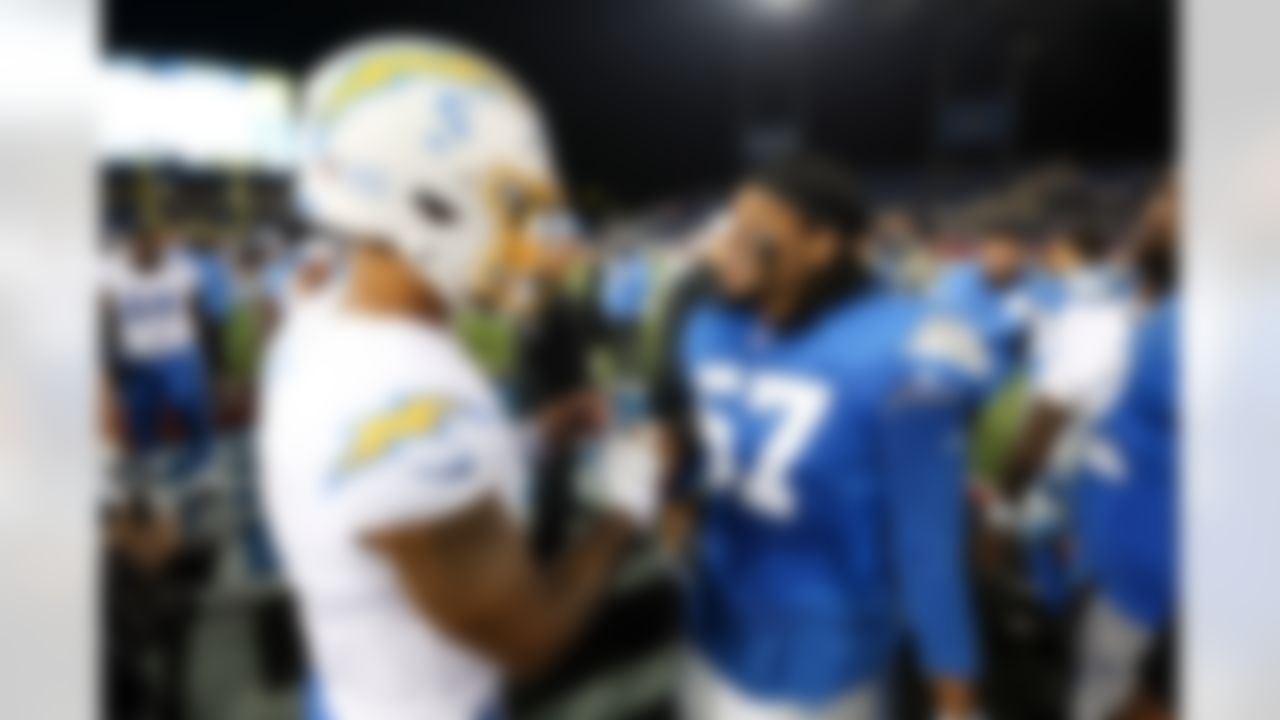 Detroit Lions defensive end Nate Lynn (57) and Los Angeles Chargers quarterback Trey Lance (5) talk after an NFL football game on Thursday, July 31, 2025 in Canton, Ohio.