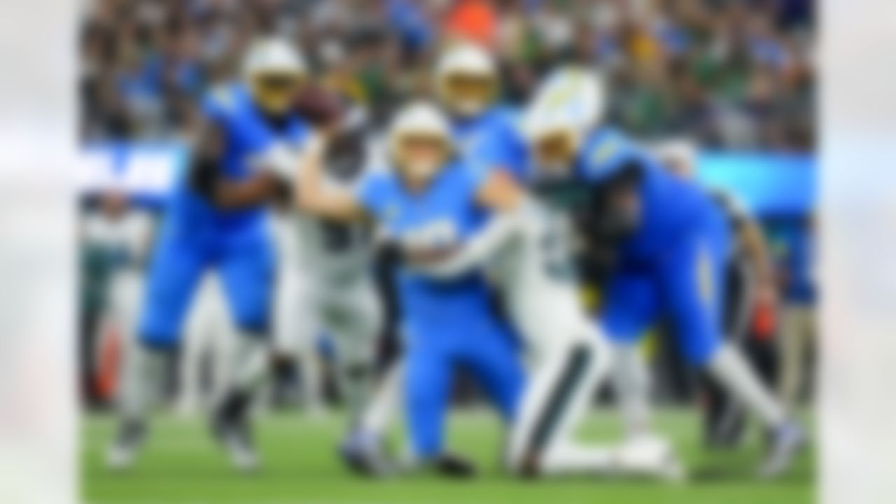 Philadelphia Eagles linebacker Jalyx Hunt (58) tackles Los Angeles Chargers quarterback Justin Herbert (10) during an NFL football game on Monday, December 8, 2025 in Inglewood, California.