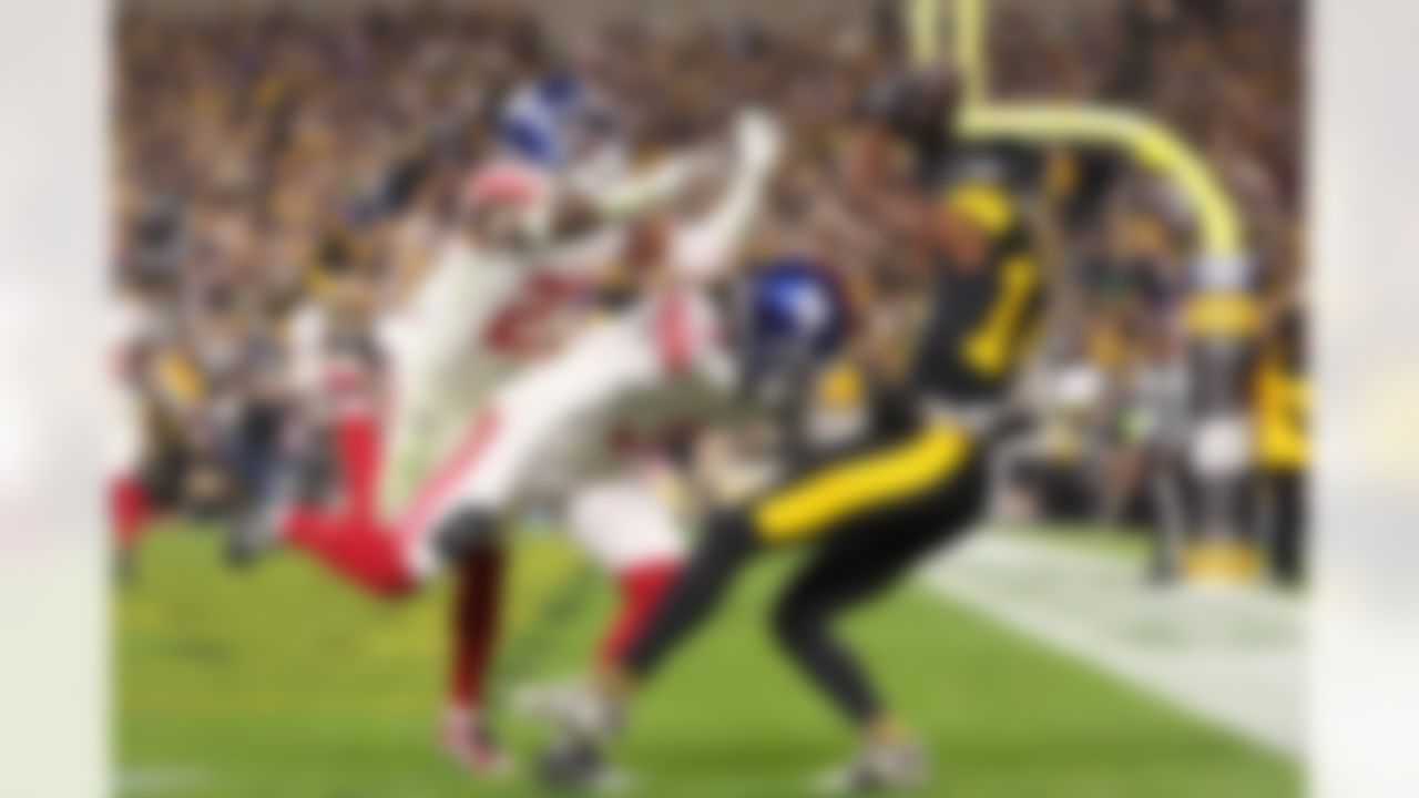 Pittsburgh Steelers wide receiver George Pickens (14) attempts to make a catch under pressure by New York Giants cornerback Deonte Banks (3) and safety Jason Pinnock (27) during an NFL football game on Monday, October 28, 2024 in Pittsburgh, Pennsylvania.