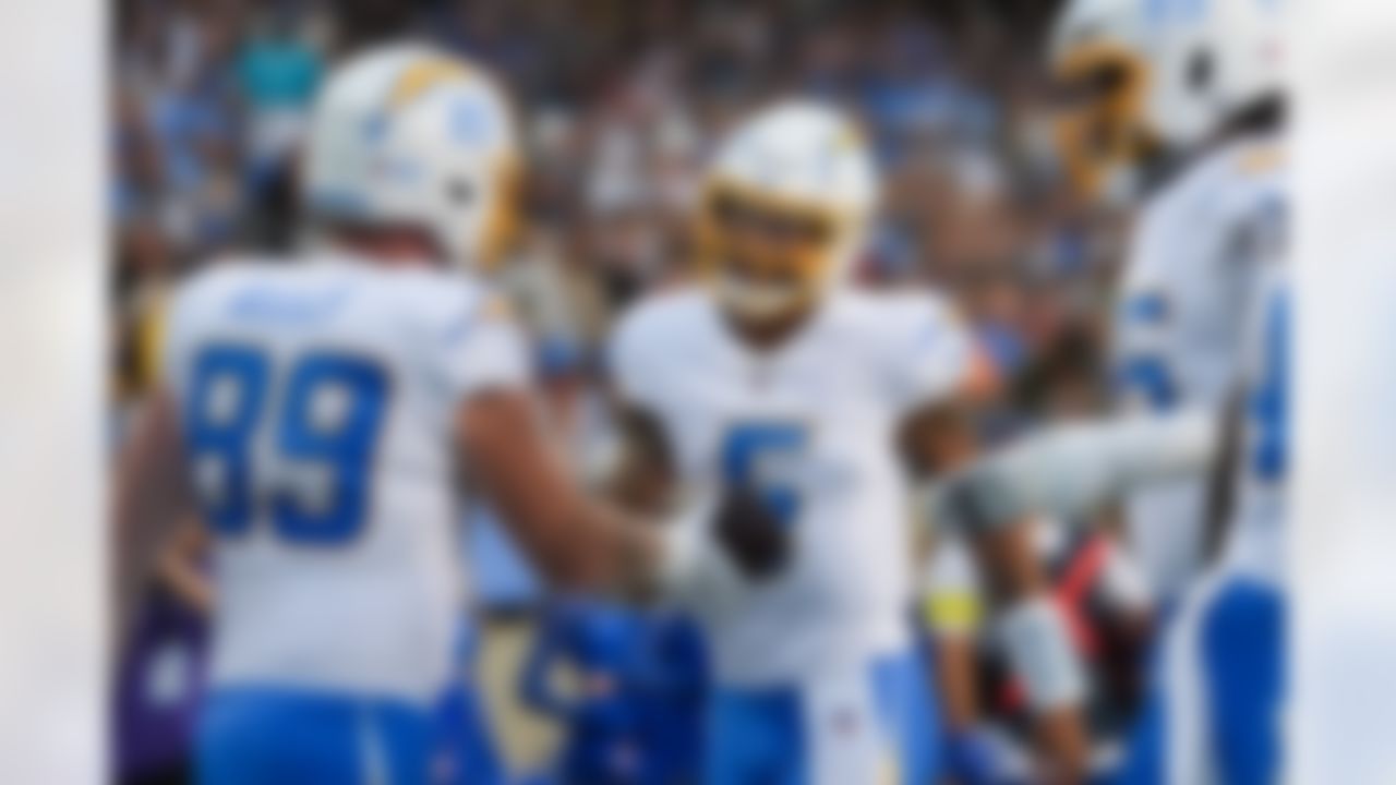 Los Angeles Chargers quarterback Trey Lance (5) celebrates with tight end Los Angeles Chargers tight end Will Dissly (89) during an NFL football game against the Detroit Lions on Thursday, July 31, 2025 in Canton, Ohio.