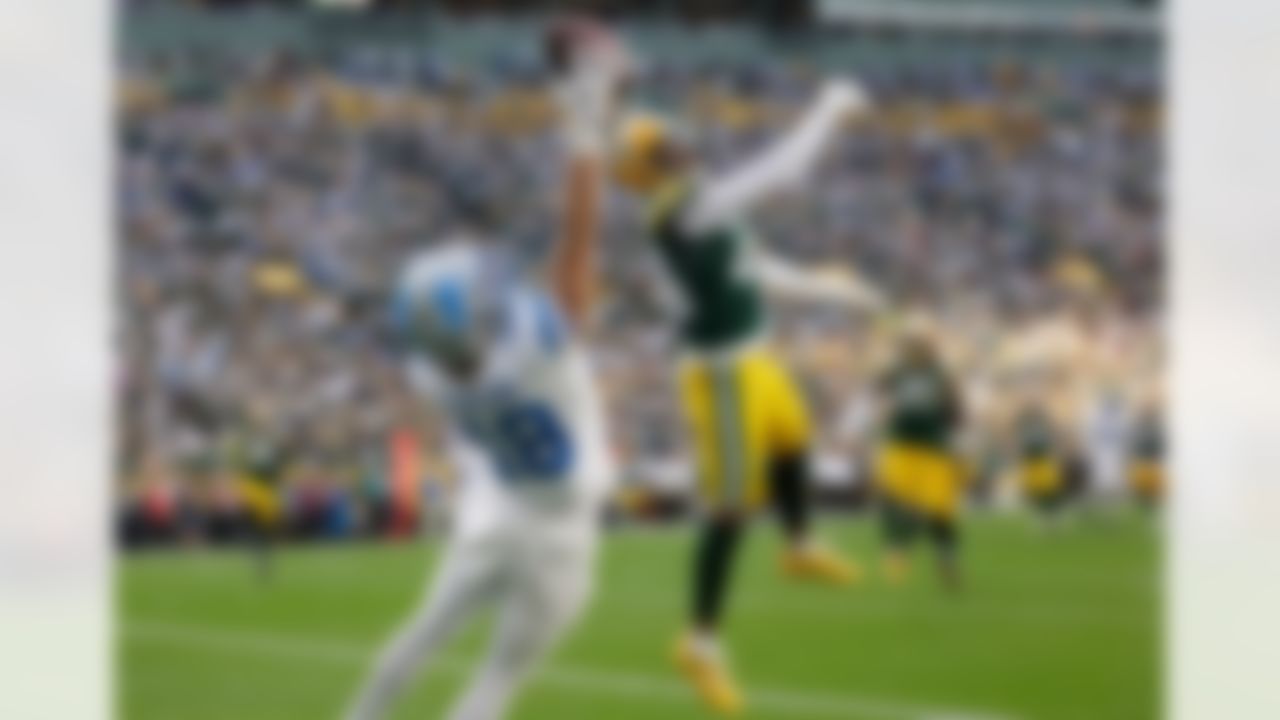 Detroit Lions wide receiver Isaac TeSlaa (18) catches a 13-yard touchdown pass as Green Bay Packers cornerback Carrington Valentine (24) defends during the second half of an NFL football game Sunday, Sept. 7, 2025, in Green Bay, Wis.