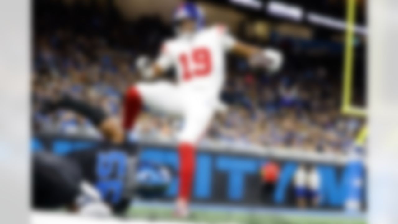 New York Giants quarterback Jameis Winston (19) breaks the tackle of Detroit Lions linebacker Derrick Barnes (55) for a touchdown during the second half of an NFL football game in Detroit, Sunday, Nov. 23, 2025.