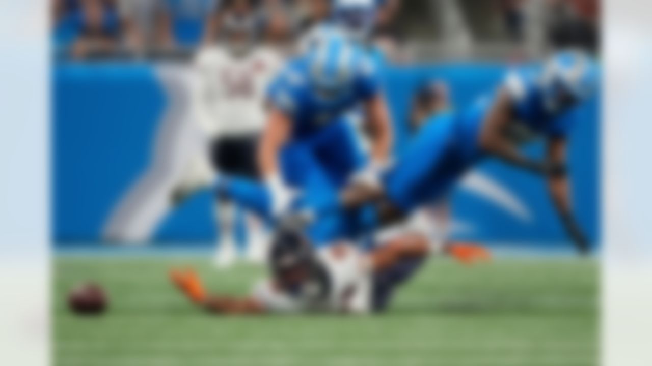 Chicago Bears wide receiver Rome Odunze (15) can't make a catch as he is defended by Detroit Lions linebacker Jack Campbell (46) and safety Brian Branch (32) during the second half of an NFL football game in Detroit, Sunday, Sept. 14, 2025.