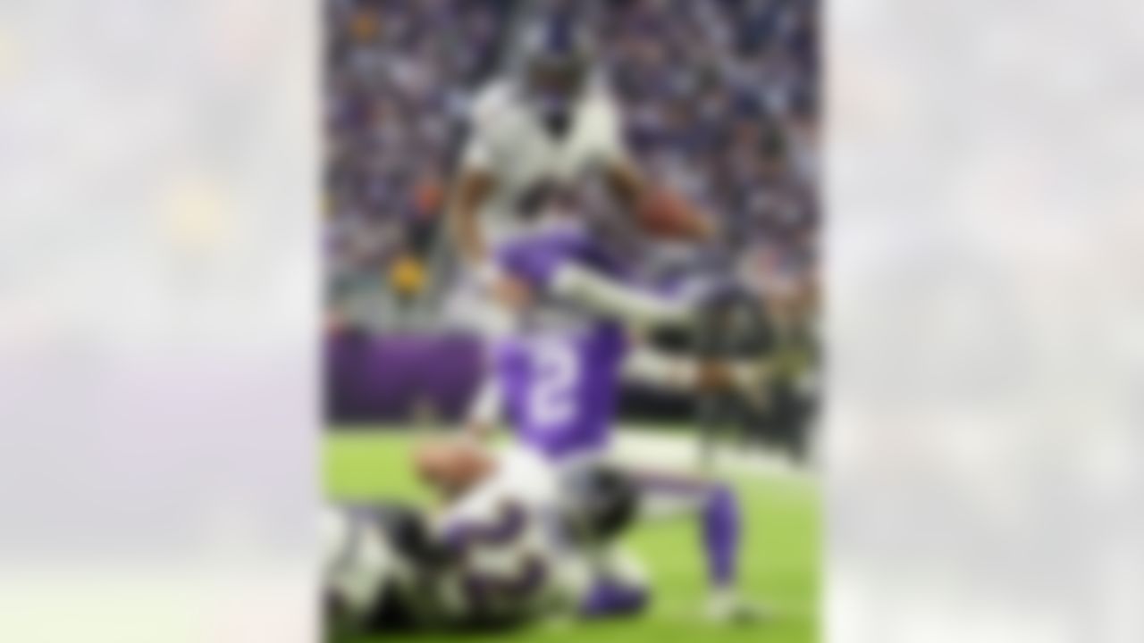 Baltimore Ravens quarterback Lamar Jackson (8) hurdles over Minnesota Vikings cornerback Isaiah Rodgers (2) near the goal line in the second half of an NFL football game, Sunday, Nov. 9, 2025, in Minneapolis.