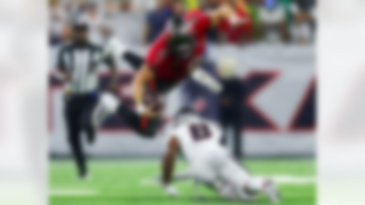 Tampa Bay Buccaneers quarterback Baker Mayfield (6) flies through the air after he was tripped up by Houston Texans safety C.J. Gardner-Johnson (8) during an NFL football game on Monday, Sept. 15, 2025 in Houston.
