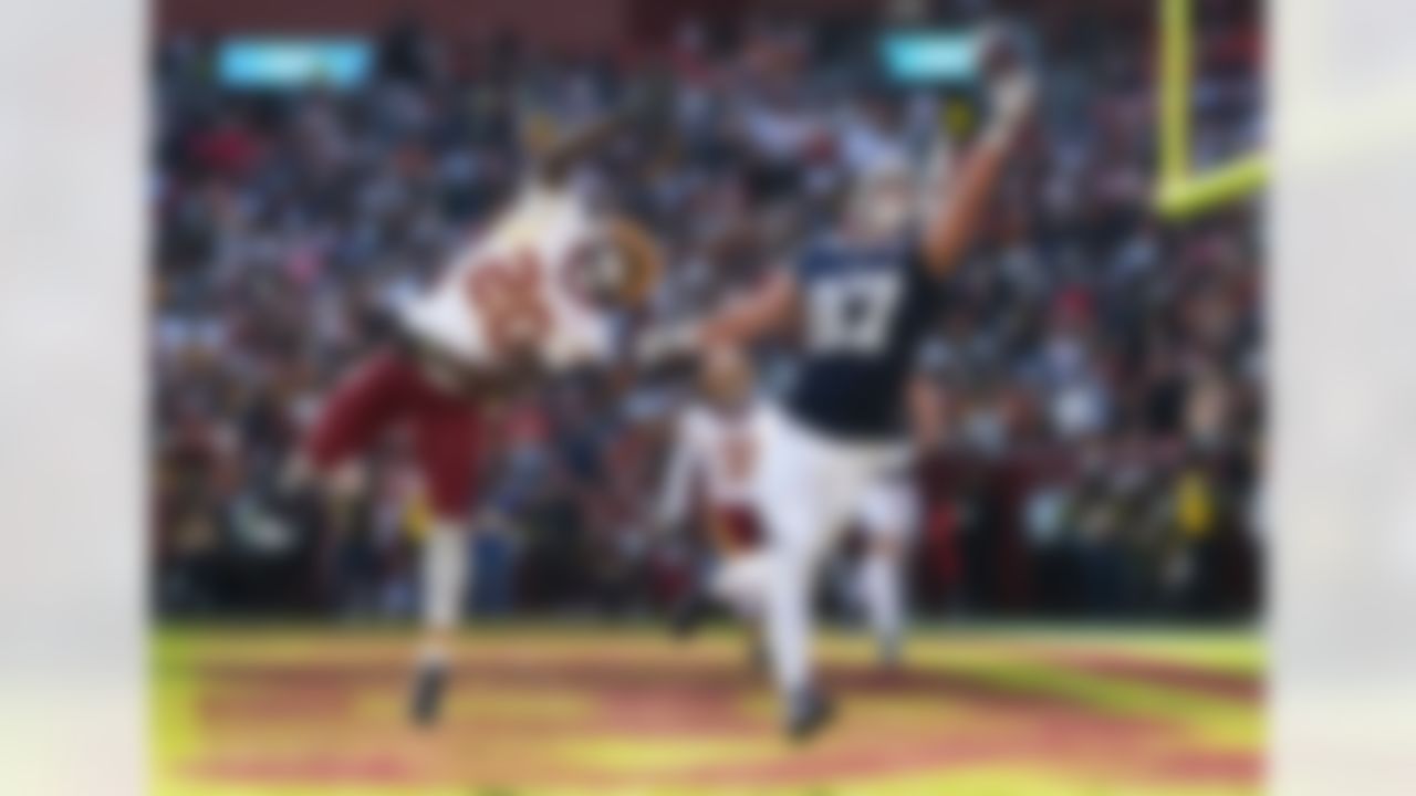 Dallas Cowboys tight end Jake Ferguson (87) catches a touchdown pass as Washington Commanders safety Quan Martin (20) defends during the first half of an NFL football game Thursday, Dec. 25, 2025, in Landover, Md.