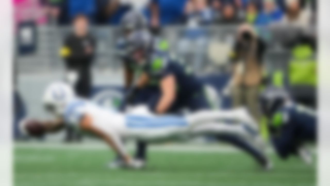 Indianapolis Colts wide receiver Michael Pittman Jr. (11) loses a shoe as he dives for yardage with Seattle Seahawks safety Ty Okada (39) tackling him during the first half of an NFL football game Sunday, Dec. 14, 2025, in Seattle.