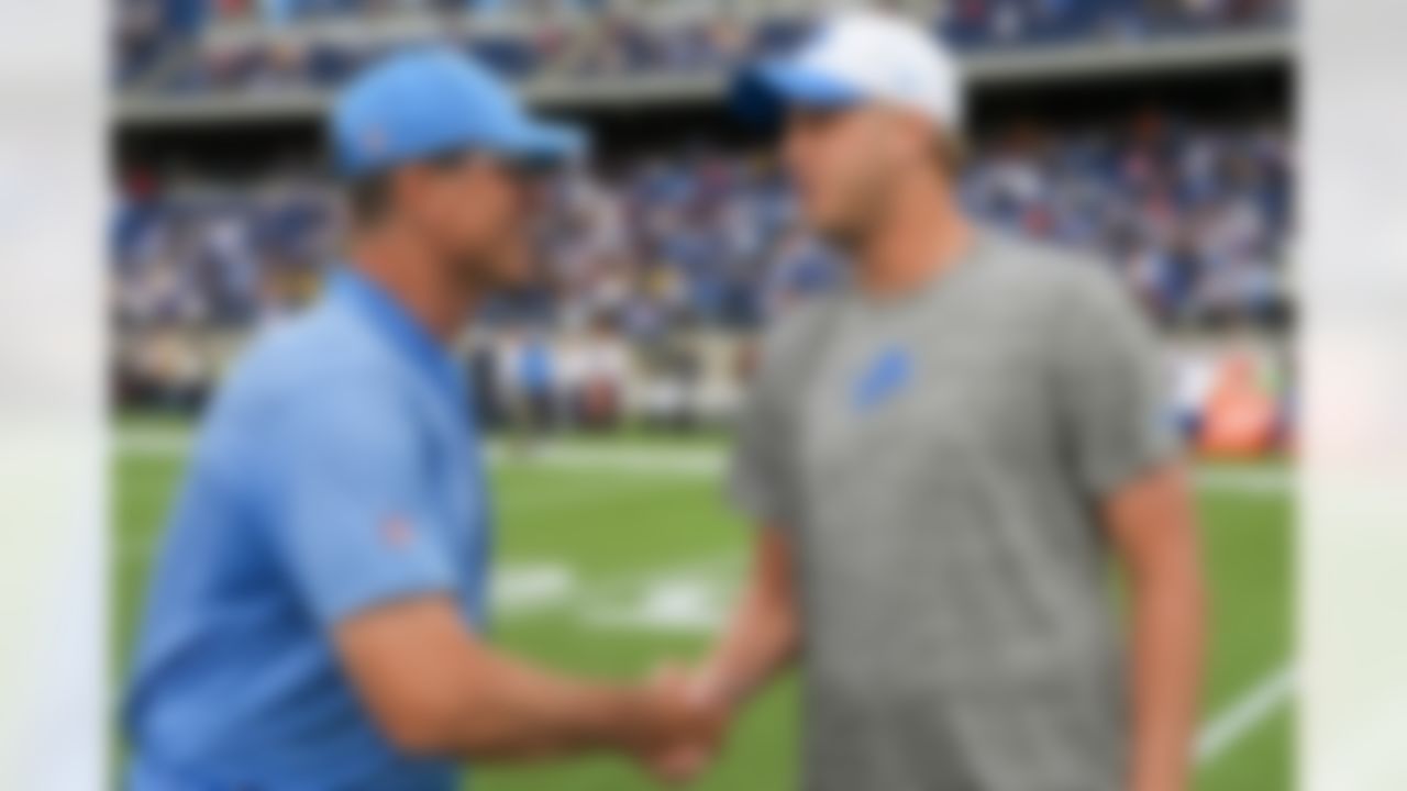 Los Angeles Chargers head coach Jim Harbaugh shakes hands with Detroit Lions quarterback Jared Goff (16) prior to an NFL football game on Thursday, July 31, 2025 in Canton, Ohio.