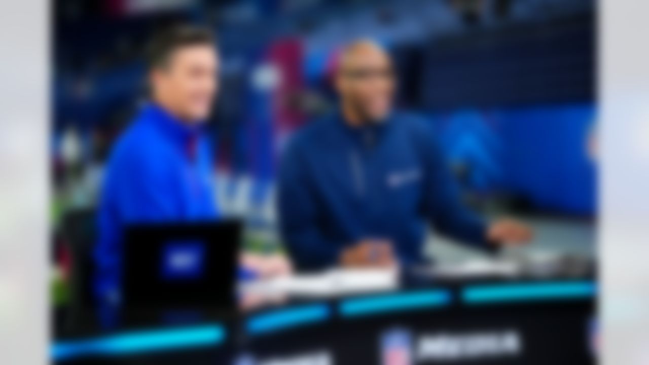 NFL Network host Rhett Lewis and analyst Bucky Brooks report during the 2026 NFL Scouting Combine on Thursday, February 26, 2026 in Indianapolis, Indiana.