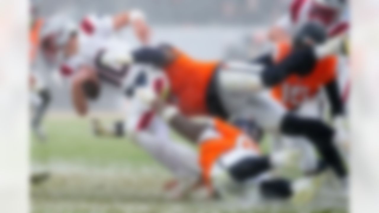 New England Patriots quarterback Drake Maye is tackled by Denver Broncos defensive tackle Malcolm Roach during the second the half of the AFC Championship NFL football game, Sunday, Jan. 25, 2026, in Denver.