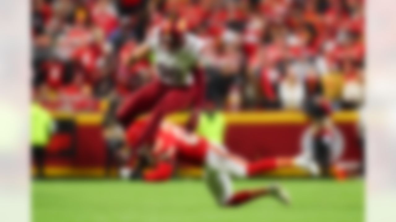 Washington Commanders tight end Zach Ertz (86) hurdles over Kansas City Chiefs safety Chamarri Conner (27) during an NFL football game against the Kansas City Chiefs on Monday, October 27, 2025 in Kansas City, Missouri.