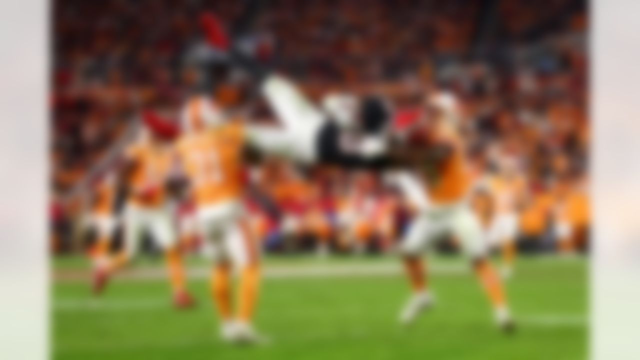 Tampa Bay Buccaneers safety Antoine Winfield Jr. (31) and safety Christian Izien (29) attempt to tackle Atlanta Falcons tight end Kyle Pitts Sr. (8) during an NFL football game on Thursday, Dec. 11, 2025 in Tampa, Florida.