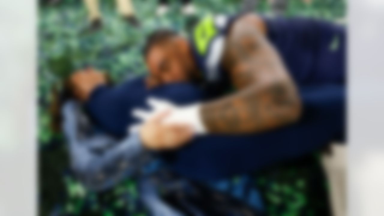 Seattle Seahawks defensive end Leonard Williams (99) and his wife, Hailey, celebrate after an NFL football game against the Los Angeles Rams on Sunday, January 25, 2026 in Seattle, Washington.