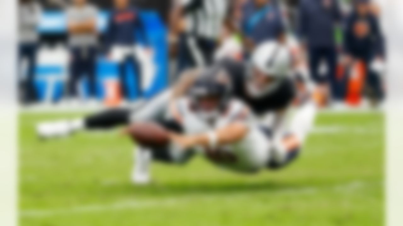 Chicago Bears quarterback Caleb Williams (18) dives for the ball against Las Vegas Raiders defensive end Maxx Crosby (98) during an NFL football game on Sunday, September 28, 2025 in Las Vegas, Nevada.