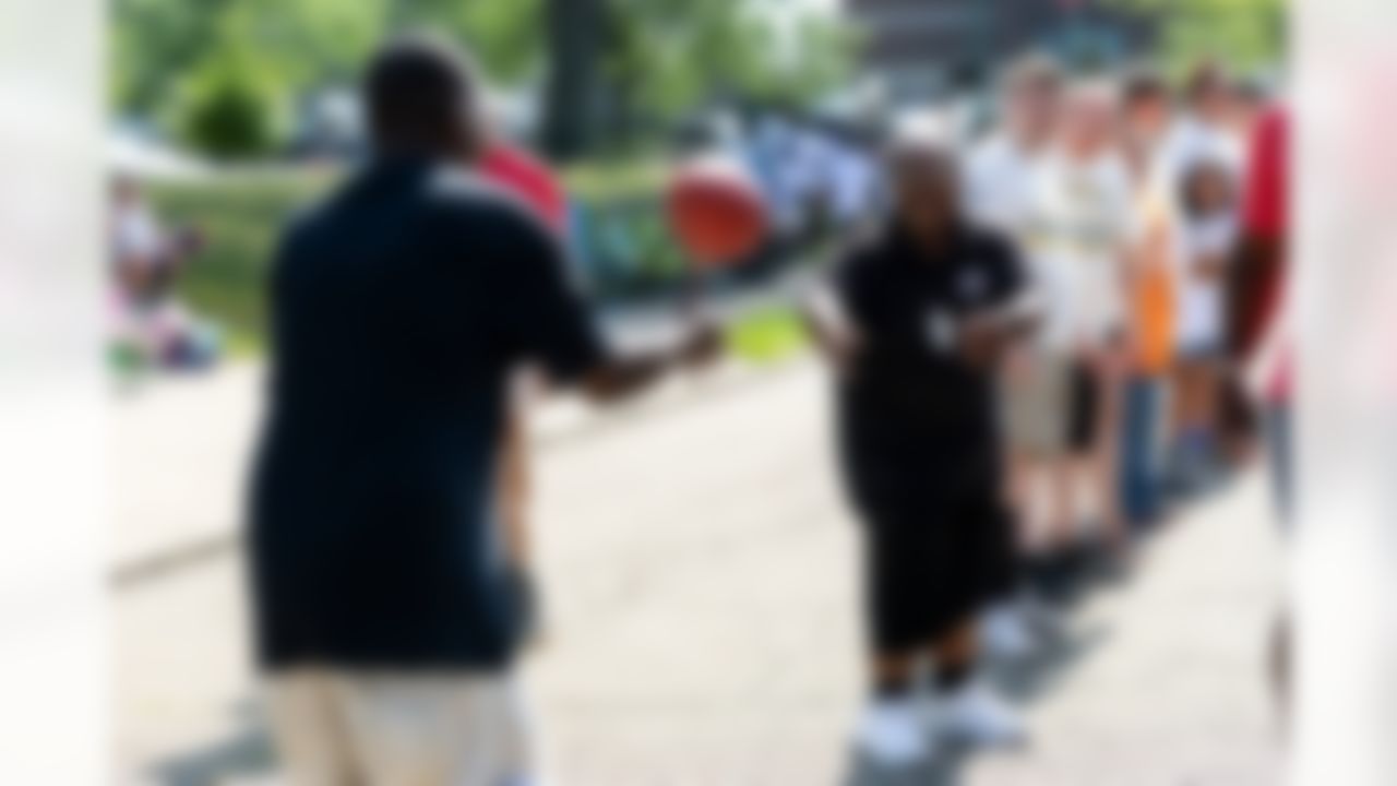 People pass the football during the Play Football First Play on Wednesday, July 30, 2025 in Canton.
