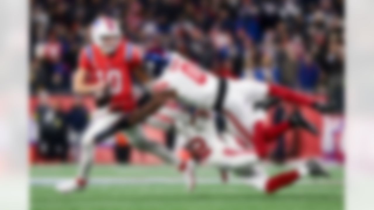 New York Giants cornerback Dru Phillips (22) and New York Giants linebacker Brian Burns (0) pressure New England Patriots quarterback Drake Maye (10) during an NFL football game on Monday, December 1, 2025 in Foxborough, Massachusetts.