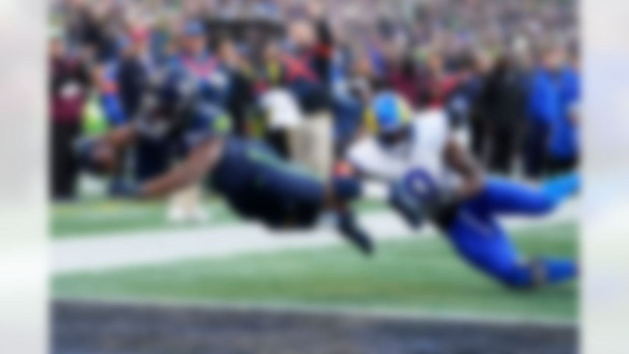 Seattle Seahawks running back Kenneth Walker III (9) scores a touchdown past Los Angeles Rams linebacker Byron Young (0) during the first half of the NFC Championship NFL football game Sunday, Jan. 25, 2026, in Seattle.