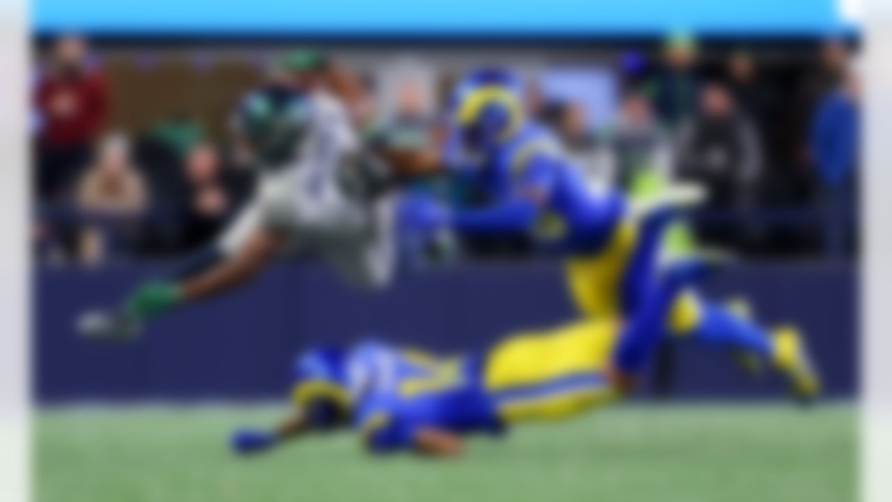 Seattle Seahawks running back Kenneth Walker III (9) hurdles with the ball during an NFL football game against the Los Angeles Rams on Thursday, December 18, 2025 in Seattle, Washington.