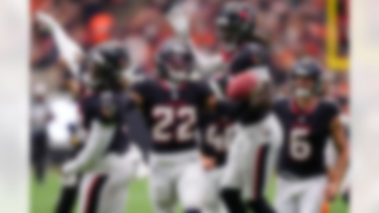 Houston Texans cornerback Jaylin Smith (22) celebrates with Tremon Smith, left, and Calen Bullock, right, after recovering a Denver Broncos turnover in the first half of an NFL football game Sunday, Nov. 2, 2025, in Houston.